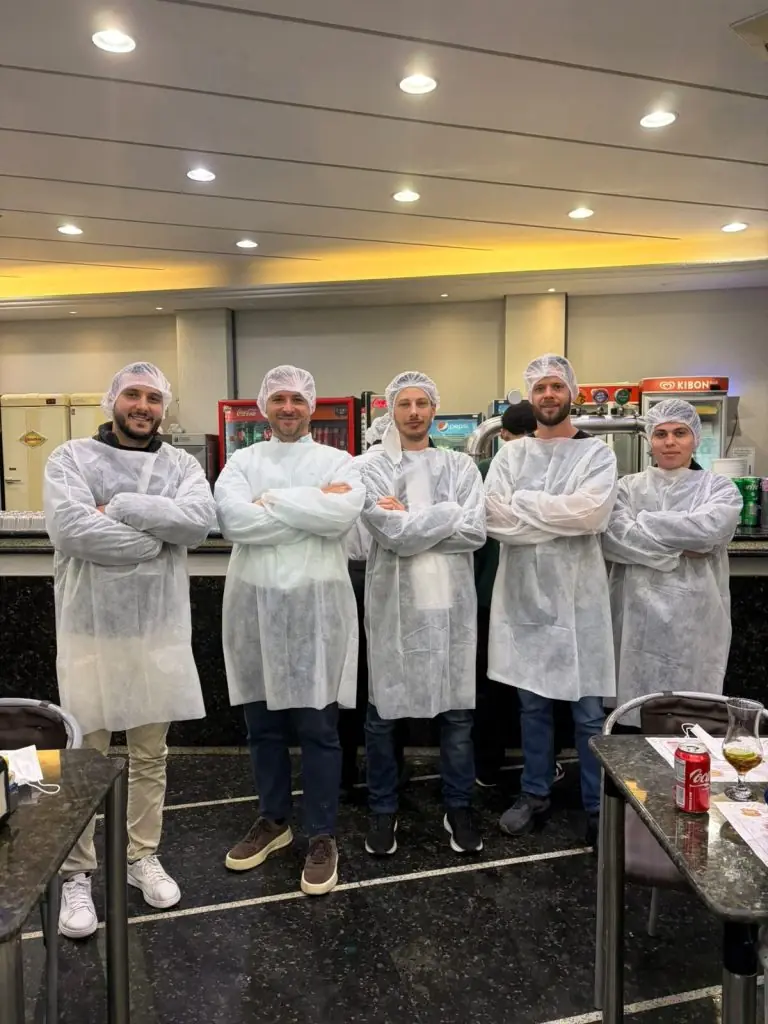grupo de pessoas vestidas com roupas de cozinha, durante visita técnica à Cepan, maior padaria da América Latina.