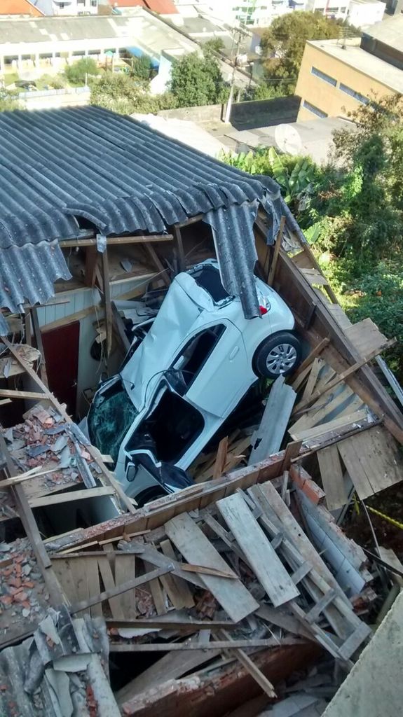 Motorista tenta estacionar carro e cai sobre a própria casa